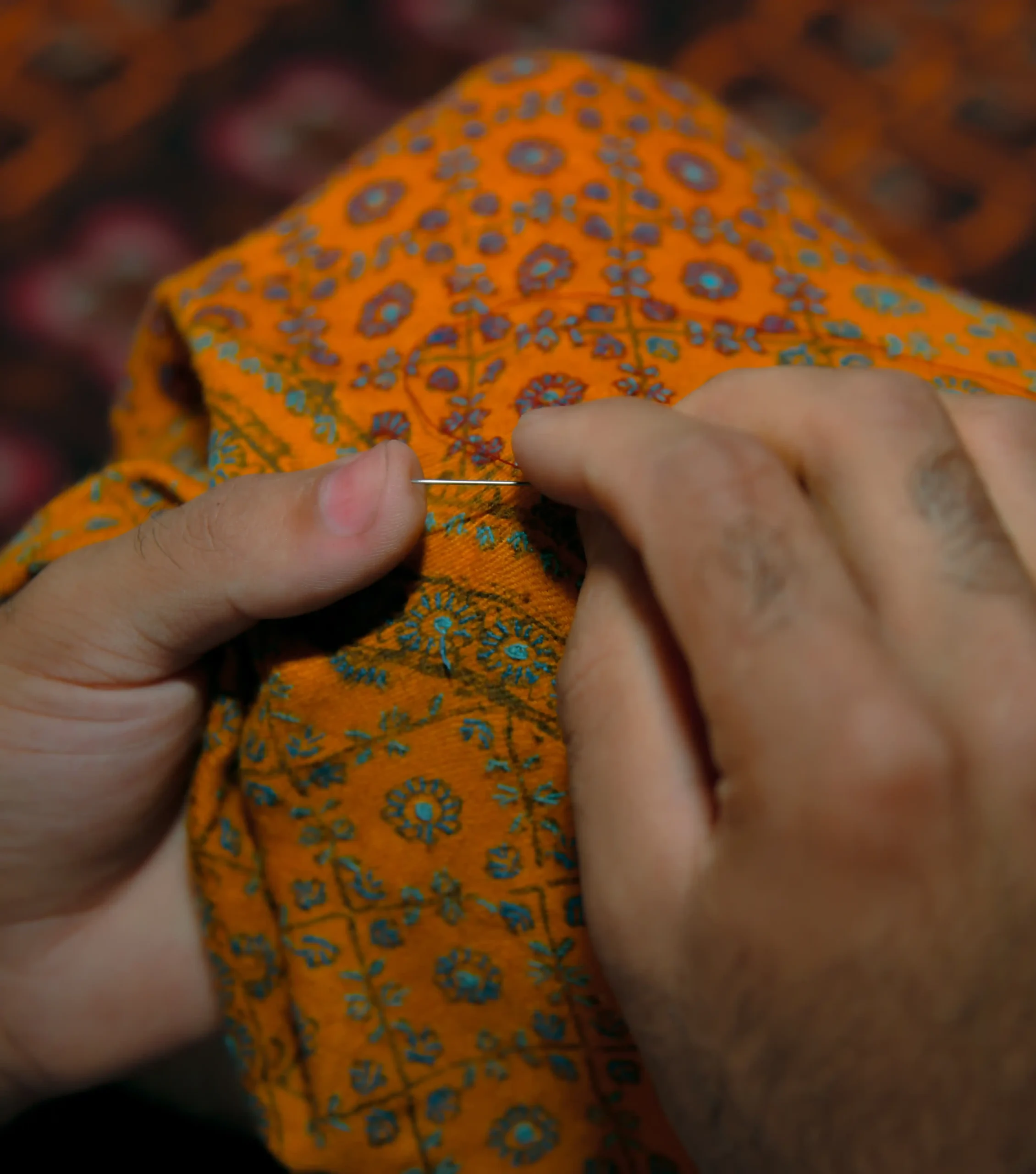 artisan doing sozni embroidery on a pashmina shawl in kashmir