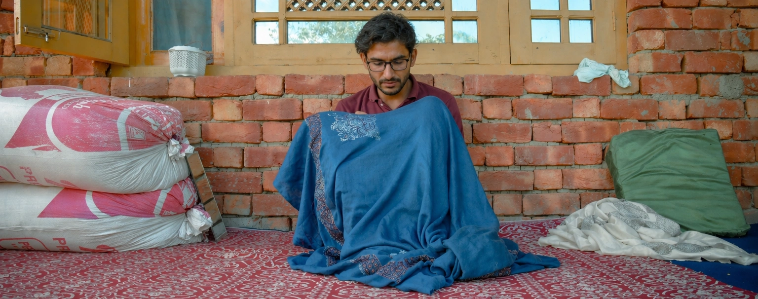 mirtex artisan working on a pashmina shawl
