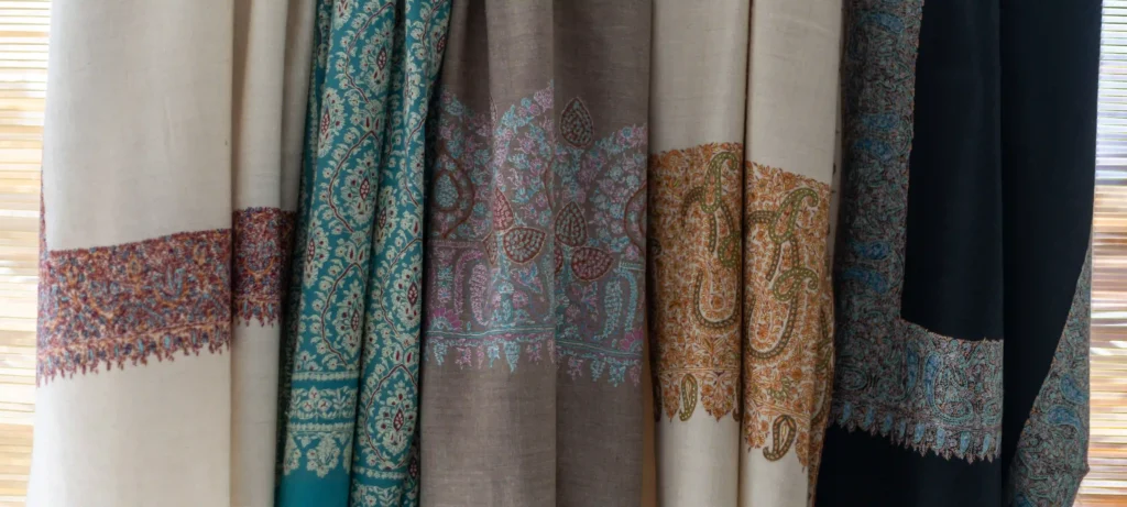 different styles of pashmina shawls hanging in kashmir